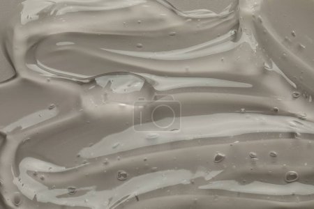Photo for Clear cosmetic gel on grey background, top view - Royalty Free Image