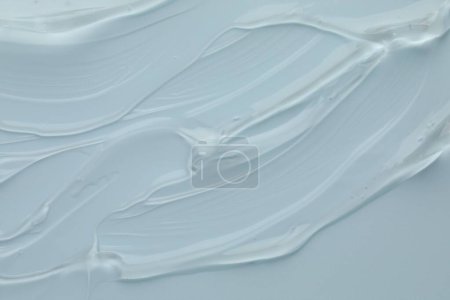 Photo for Clear cosmetic gel on light blue background, top view - Royalty Free Image