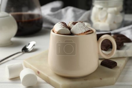 Photo for Cup of aromatic hot chocolate with marshmallows and cocoa powder on table, closeup - Royalty Free Image