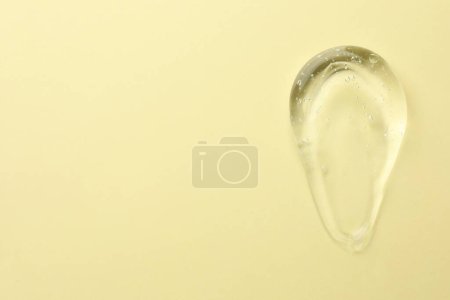 Photo for Clear cosmetic gel on yellow background, top view. Space for text - Royalty Free Image