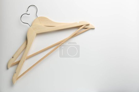 Photo for Wooden hangers on white background, top view. Space for text - Royalty Free Image
