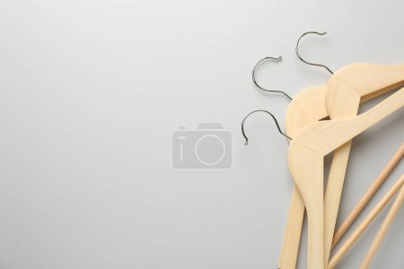 Photo for Wooden hangers on light gray background, top view. Space for text - Royalty Free Image