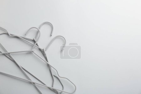 Photo for Hangers on light gray background, top view. Space for text - Royalty Free Image