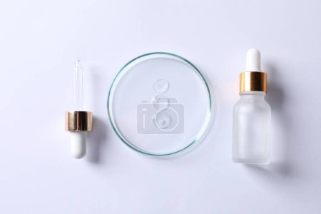 Photo for Petri dish with cosmetic serum, pipette and bottle on white background, flat lay - Royalty Free Image