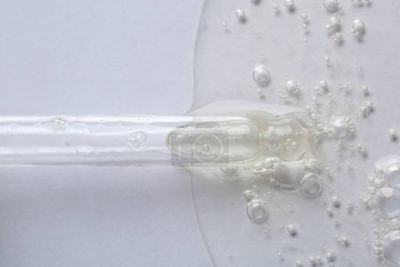 Photo for Pipette with cosmetic serum on white background, macro view - Royalty Free Image
