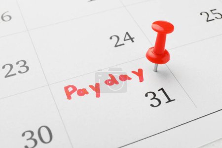 Photo for Calendar page with red pin on payday date, closeup - Royalty Free Image