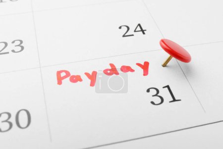 Photo for Calendar page with red pin on payday date, closeup - Royalty Free Image