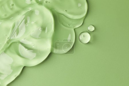 Photo for Clear cosmetic gel on light green background, top view. Space for text - Royalty Free Image