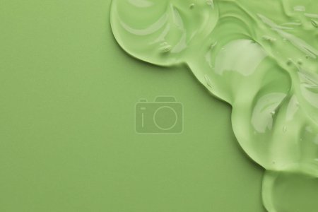 Photo for Clear cosmetic gel on light green background, top view. Space for text - Royalty Free Image