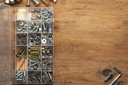 Photo for Organizer with many different fasteners on wooden table, flat lay. Space for text - Royalty Free Image