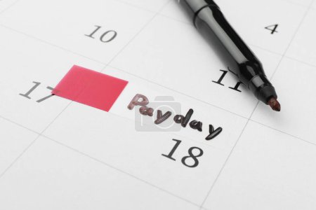Photo for Black felt pen on calendar page with marked payday date, closeup - Royalty Free Image