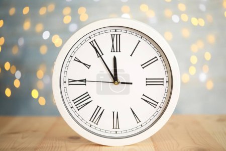 Photo for Clock showing five minutes until midnight on blurred background. New Year countdown - Royalty Free Image