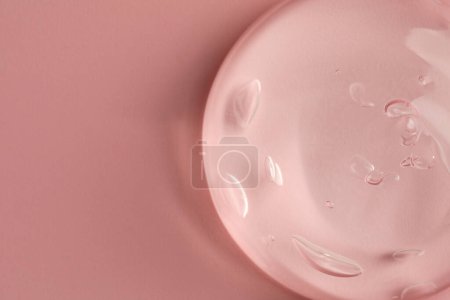 Photo for Sample of clear cosmetic gel on pink background, top view. Space for text - Royalty Free Image