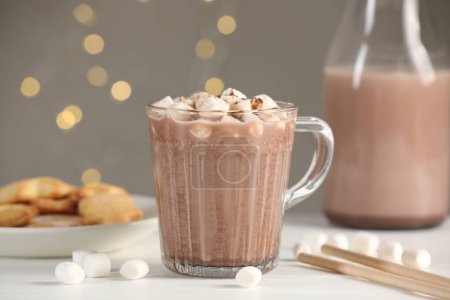 Photo for Cup of aromatic hot chocolate with marshmallows and cocoa powder on white table, closeup - Royalty Free Image