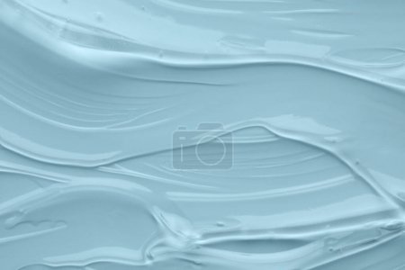 Photo for Clear cosmetic gel on light blue background, top view - Royalty Free Image