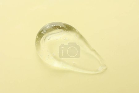 Photo for Clear cosmetic gel on yellow background, top view - Royalty Free Image