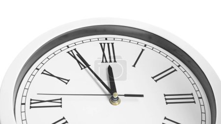 Uhr zeigt fünf Minuten bis Mitternacht auf weißem Hintergrund, Nahaufnahme. Countdown zum neuen Jahr