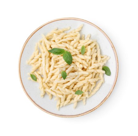Plate of delicious trofie pasta with basil leaves isolated on white, top view