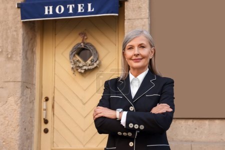 Photo for Portrait of smiling business owner near her hotel outdoors, space for text - Royalty Free Image