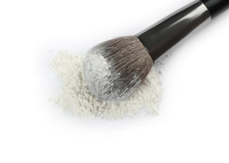 Makeup brush with rice loose face powder on white background, top view