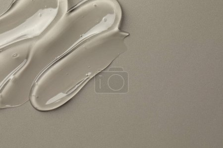 Photo for Sample of clear cosmetic gel on grey background, top view. Space for text - Royalty Free Image