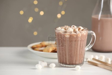 Photo for Cup of aromatic hot chocolate with marshmallows and cocoa powder on white table, closeup. Space for text - Royalty Free Image