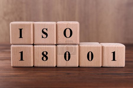 Cubes with abbreviation ISO and number 18001 on wooden table