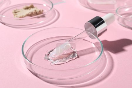 Photo for Pipette, cosmetic serum and petri dishes with samples on pink background, closeup - Royalty Free Image