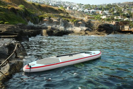 One SUP board with paddle near sea shore