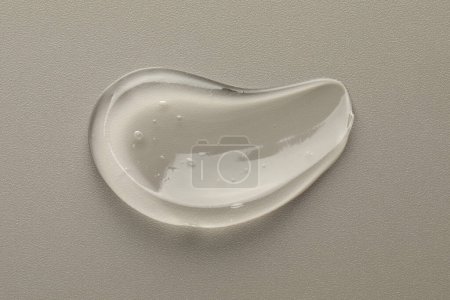Photo for Smear of clear cosmetic gel on grey background, top view - Royalty Free Image