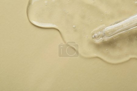 Photo for Pipette with cosmetic serum on beige background, top view. Space for text - Royalty Free Image