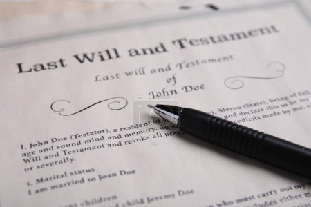 Last will and testament with pen on table, closeup