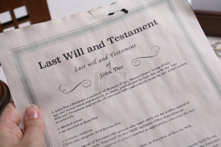Photo for Woman holding last will and testament at table, closeup - Royalty Free Image