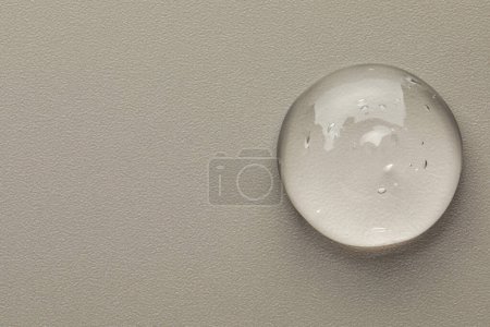 Photo for Sample of clear cosmetic gel on grey background, top view. Space for text - Royalty Free Image