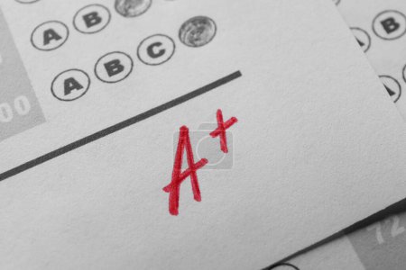 Photo for School grade. Red letter A with plus symbol on answer sheet, closeup - Royalty Free Image