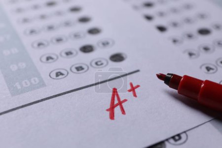 Photo for School grade. Letter A with plus symbol on answer sheet and red marker, closeup - Royalty Free Image