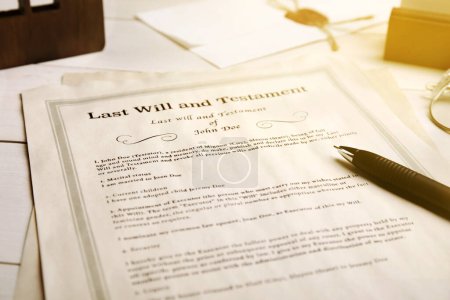 Last Will and Testament with pen on table, closeup
