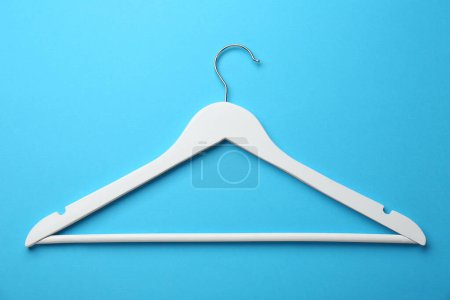 Photo for White hanger on light blue background, top view - Royalty Free Image
