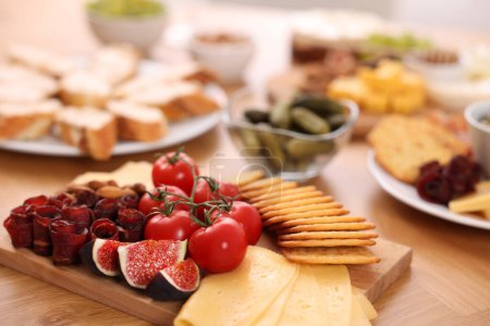 Photo for Assorted appetizers served on wooden table, selective focus. Space for text - Royalty Free Image