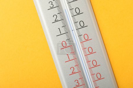 Modern weather thermometer on yellow background, closeup