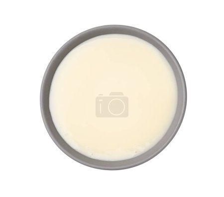 Bowl with condensed milk isolated on white, top view