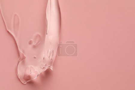 Photo for Sample of clear cosmetic gel on pink background, top view. Space for text - Royalty Free Image