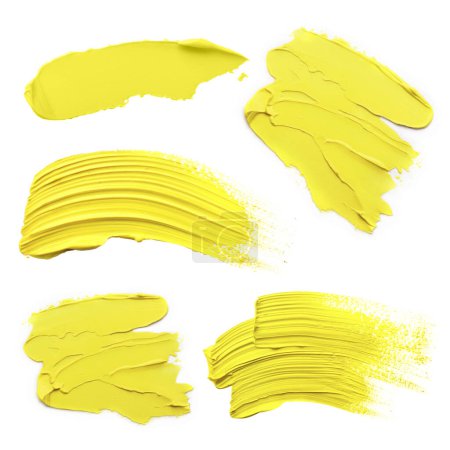 Yellow oil paint strokes isolated on white, top view