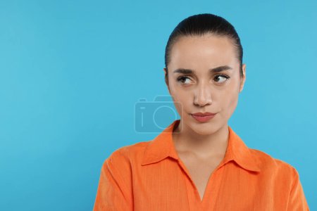 Photo for Portrait of resentful woman on light blue background. Space for text - Royalty Free Image
