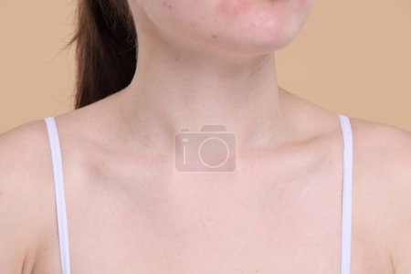 Closeup view of woman with healthy skin on beige background