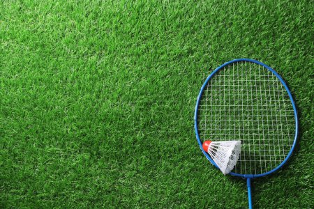 Photo for Two badminton racket and shuttlecock on green grass, top view with space for text - Royalty Free Image