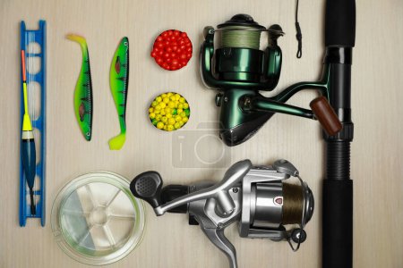 Photo for Fishing tackle on wooden background, flat lay - Royalty Free Image