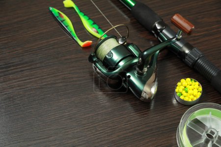 Photo for Fishing tackle on dark wooden background, closeup. Space for text - Royalty Free Image