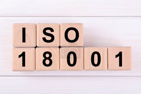 International Organization for Standardization. Cubes with abbreviation ISO and number 18001 on white wooden table, flat lay