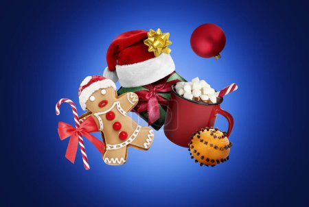 Photo for Christmas celebration. Different festive stuff in air on blue gradient background - Royalty Free Image
